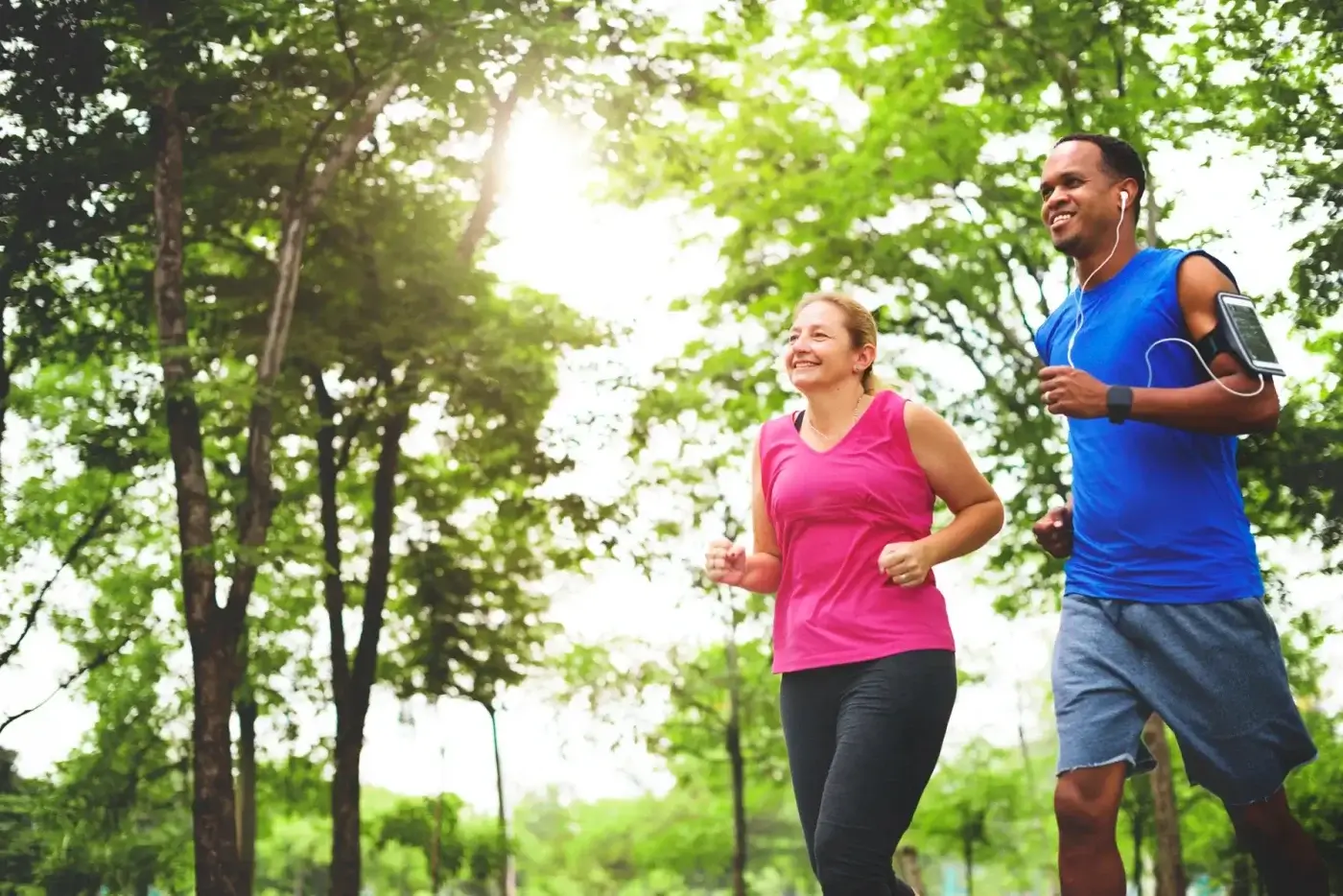 Two people jogging in the park, enjoying their physical freedom.