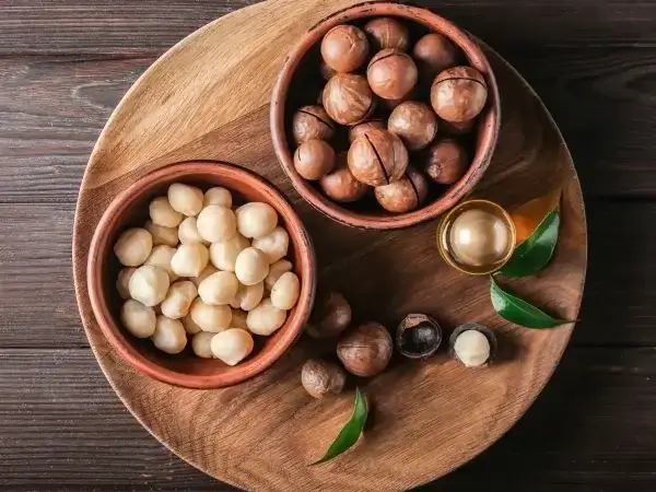 Hazelnuts in a bowl on a wooden table.