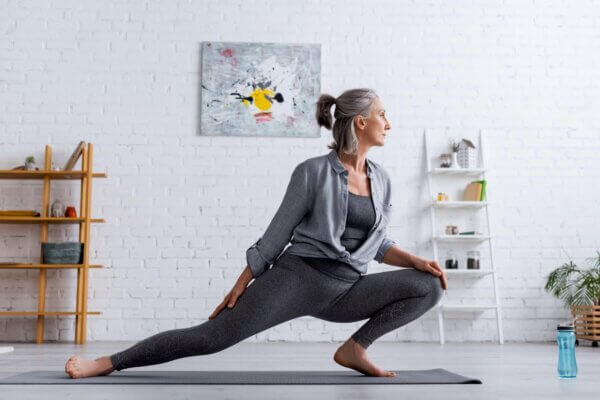 A woman is practicing yoga in the comfort of her home.